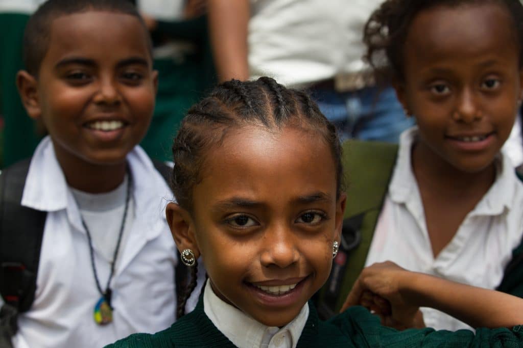 Children smiling together — Cane for Generation